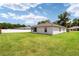 Green grassy backyard with screened porch at 3107 Ne 24 Pl, Ocala, FL 34470