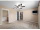 Spacious bedroom with ceiling fan and ensuite bathroom access at 3107 Ne 24 Pl, Ocala, FL 34470