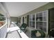 Spacious front porch with rocking chairs, offering a relaxing view at 5537 Sw 38 St, Ocala, FL 34474