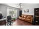 Bright home office features a leather couch, wood floors, and built-in shelving at 5537 Sw 38 St, Ocala, FL 34474