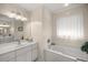 Bathroom features a soaking tub, double vanity, and tile flooring at 5537 Sw 38 St, Ocala, FL 34474