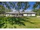 Single story home with gray roof, green exterior, and manicured lawn at 5537 Sw 38 St, Ocala, FL 34474