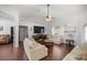 Living room with vaulted ceiling, hardwood floors, and comfortable seating at 5537 Sw 38 St, Ocala, FL 34474
