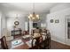 Bright dining room with a large wood table and chandelier at 5537 Sw 38 St, Ocala, FL 34474
