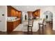 Kitchen with granite countertops, wood cabinets and breakfast bar at 5537 Sw 38 St, Ocala, FL 34474