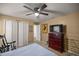 Bedroom with dresser, closet, and ceiling fan at 5537 Sw 38 St, Ocala, FL 34474
