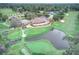 Aerial view of country club with golf course, pool, and tennis courts at 7070 Se 14Th Ct, Ocala, FL 34480