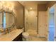 Elegant bathroom with a walk-in shower and octagonal mirror at 7070 Se 14Th Ct, Ocala, FL 34480