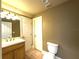 Clean bathroom with vanity, toilet, and access to another room at 7070 Se 14Th Ct, Ocala, FL 34480