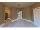 Spacious bedroom with neutral carpeting and access to another room at 7070 Se 14Th Ct, Ocala, FL 34480