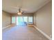 Spacious bedroom with carpet flooring and access to a patio at 7070 Se 14Th Ct, Ocala, FL 34480
