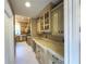 Well-appointed butlers pantry with extensive cabinetry and wine cooler at 7070 Se 14Th Ct, Ocala, FL 34480