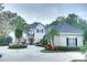 Two-story house with a gray roof, landscaped yard, and circular driveway at 7070 Se 14Th Ct, Ocala, FL 34480