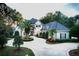 Two-story house with a gray roof, landscaped yard, and circular driveway at 7070 Se 14Th Ct, Ocala, FL 34480