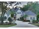 Two-story house with a gray roof, landscaped yard, and circular driveway at 7070 Se 14Th Ct, Ocala, FL 34480