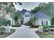 Two-story house with a gray roof, landscaped yard, and circular driveway at 7070 Se 14Th Ct, Ocala, FL 34480