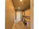 Spacious hallway with neutral paint and carpet and access to bedrooms and office at 7070 Se 14Th Ct, Ocala, FL 34480