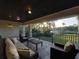 Covered patio with comfortable seating, offering stunning golf course views at 7070 Se 14Th Ct, Ocala, FL 34480