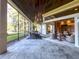 Open and airy screened patio with a dining area and access to the house at 7070 Se 14Th Ct, Ocala, FL 34480