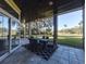 Enjoy this screened patio, complete with dining area and golf course view at 7070 Se 14Th Ct, Ocala, FL 34480