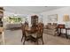 Open concept dining area with wood table and chairs near living room at 9859 Sw 97Th St, Ocala, FL 34481