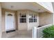 Front entryway with white door, brick walls, and small window at 9859 Sw 97Th St, Ocala, FL 34481