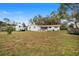 Spacious backyard with grassy area, patio, and trampoline at 3725 Se 8Th St, Ocala, FL 34471