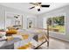 Bedroom with wood-look floors, sliding mirrored closets, and a view at 3725 Se 8Th St, Ocala, FL 34471