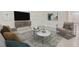Living room features modern furniture and large TV at 8457 Las Palmas Way, Wildwood, FL 34785