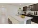 Modern kitchen with an island and stainless steel appliances at 8457 Las Palmas Way, Wildwood, FL 34785