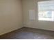 Spacious bedroom with neutral carpeting and large window at 1125 Paradise Dr # D, Lady Lake, FL 32159