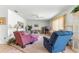 Relaxing living room with carpeted floor, comfortable furniture, and large window at 17855 Se 99Th Ave, Summerfield, FL 34491