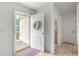 Inviting entryway with wreath, light flooring and interior view at 17855 Se 99Th Ave, Summerfield, FL 34491