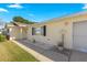Light yellow single story home with walkway and small garden at 17855 Se 99Th Ave, Summerfield, FL 34491