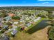 An aerial view of a house located in a community by a pond at 17855 Se 99Th Ave, Summerfield, FL 34491