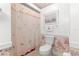 Bathroom with floral wallpaper, toilet, and shower/tub combo at 17855 Se 99Th Ave, Summerfield, FL 34491