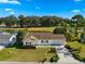 Aerial view of a single-story house with a two-car garage, situated on a golf course at 17855 Se 99Th Ave, Summerfield, FL 34491