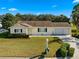 House exterior showcasing a manicured lawn and driveway at 17855 Se 99Th Ave, Summerfield, FL 34491