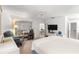 Spacious main bedroom with a king bed and adjacent sitting area at 17855 Se 99Th Ave, Summerfield, FL 34491