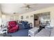 Relaxing sunroom with comfortable seating and ceiling fans at 17855 Se 99Th Ave, Summerfield, FL 34491