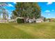 Landscaped backyard with mature trees and green grass at 17855 Se 99Th Ave, Summerfield, FL 34491