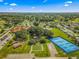 Aerial view showing community clubhouse, tennis courts, and putting greens at 17855 Se 99Th Ave, Summerfield, FL 34491
