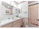 Clean bathroom with floral wallpaper, shower/tub combo, and vanity at 17855 Se 99Th Ave, Summerfield, FL 34491