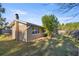 Backyard view of home showcasing a large tree and grassy area at 17 Sapphire Rd, Ocala, FL 34472