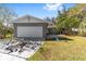 Gray house with a white garage door and a stone patio at 729 Se 32Nd Ave, Ocala, FL 34471