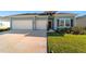 Two-story home with light blue siding and two-car garage at 7930 Sw 74Th Loop, Ocala, FL 34481