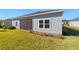 House exterior showcasing a screened patio and grassy backyard at 7930 Sw 74Th Loop, Ocala, FL 34481
