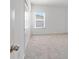 Bedroom with carpet, window, and double doors at 7930 Sw 74Th Loop, Ocala, FL 34481