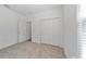 Bright bedroom with neutral walls and carpet, plus a closet at 7930 Sw 74Th Loop, Ocala, FL 34481