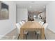 Dining area with a long wooden table and six white chairs at 7930 Sw 74Th Loop, Ocala, FL 34481